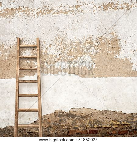 stucco wall with wooden ladder