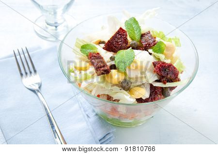 Seven-layer salad with egg tuna dried tomatoes and carrots