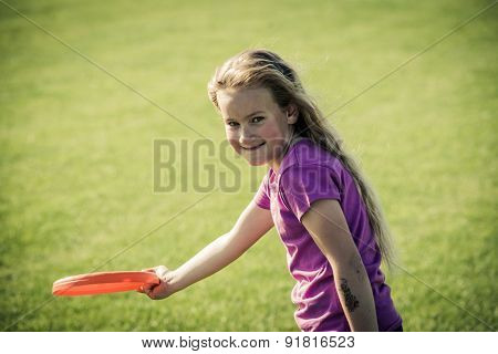Cute girl playing with freesbi