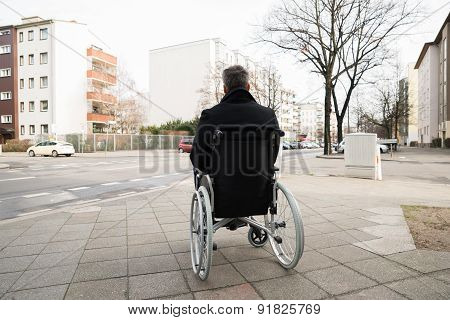 Disabled Man On Wheelchair Looking At Street
