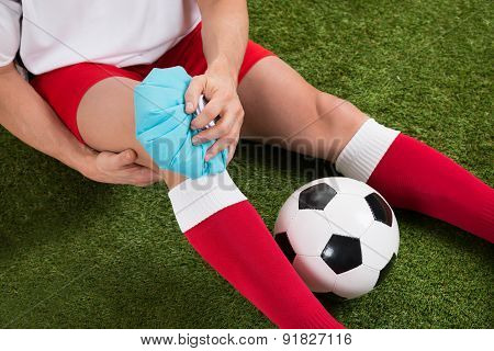 Soccer Player Icing Knee With Ice Pack