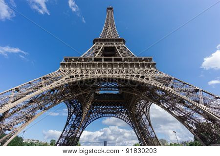The Eiffel Tower and Montparnasse tower over blue sky