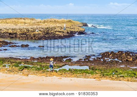 OUALIDIA, MOROCCO, APRIL 6, 2015:  Boy-fisherman carries bucket with freshly caught seafood