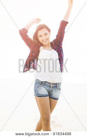 Portrtait of a happy girl at the beach enjoying the life