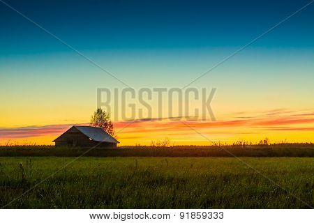 Small Barn House Against The Sunset