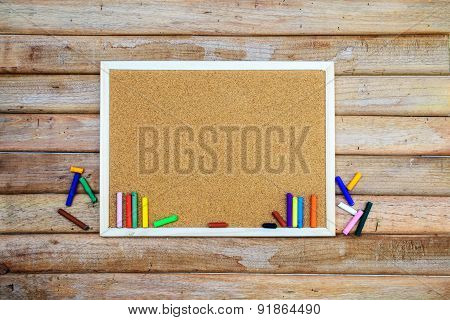 Oil Pastels With Cockboard On Old Wooden Background
