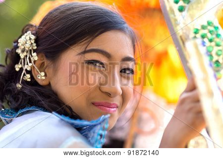 BAGAN, MYANMAR, JANUARY 22, 2015: Portrait of a Burmese beautiful woman in traditional dress and makeup for a religious Buddhist celebration in Bagan, Myanmar (Burma)