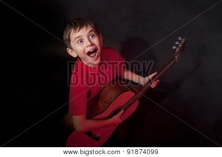 Emotionally Singing Boy With Guitar