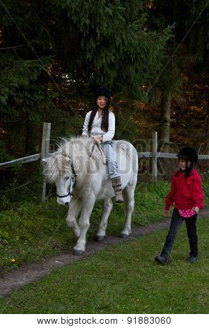 Girl Ridding A White Horse In Denmark