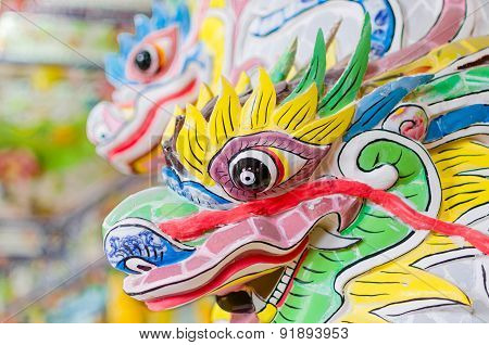 Festive colourful dragon stone head in buddha temple