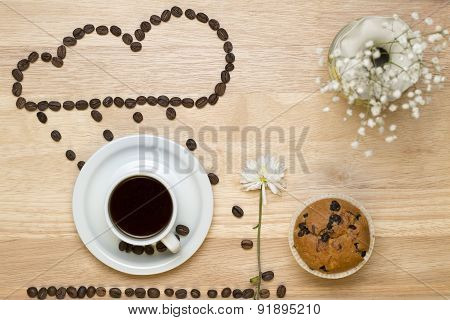 Top view coffee,muffins,flower and coffee beans