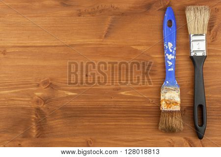 Paint brush on wooden background. Sales of paints and brushes. Housework. Supplies for painters.