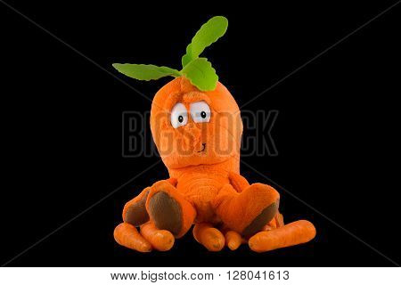 an orange puppet and some orange carrots