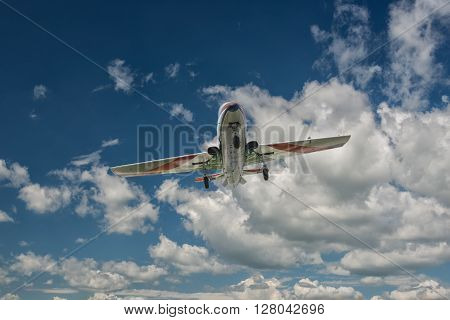 a plane flying in a beautiful blue sky