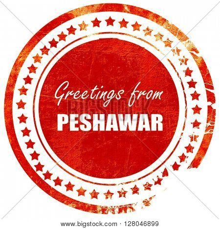 Greetings from peshawar, grunge red rubber stamp  on a solid white background