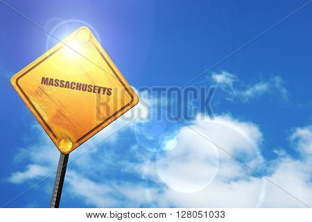 Yellow road sign with a blue sky and white clouds:  masschusetts
