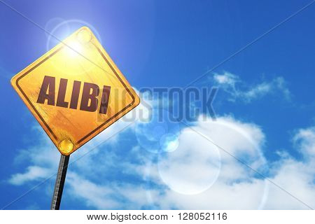Yellow road sign with a blue sky and white clouds: alibi