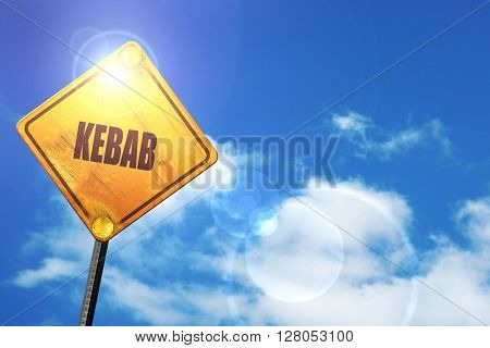 Yellow road sign with a blue sky and white clouds: Delicious keb