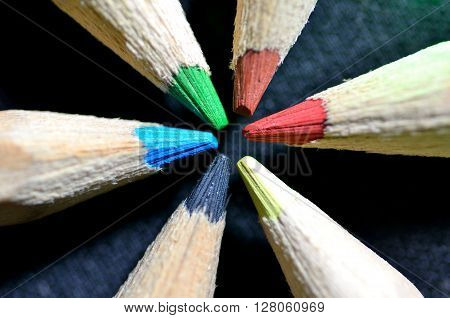 Close-up picture of color pencils on black background