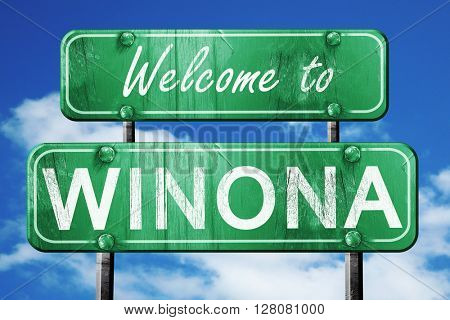 winona vintage green road sign with blue sky background