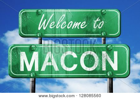 macon vintage green road sign with blue sky background