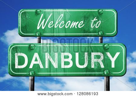 danbury vintage green road sign with blue sky background