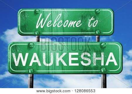 waukesha vintage green road sign with blue sky background