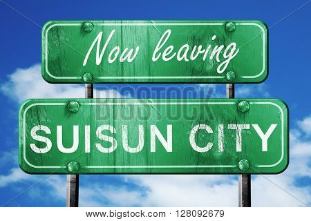 Leaving suisun city, green vintage road sign with rough letterin