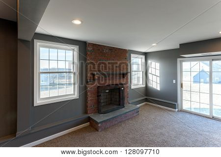 Beautiful staged interior finished basement family room in a modern house.