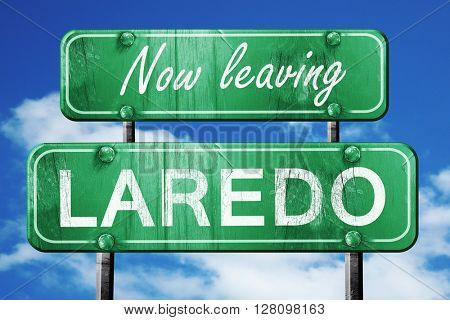 Leaving laredo, green vintage road sign with rough lettering