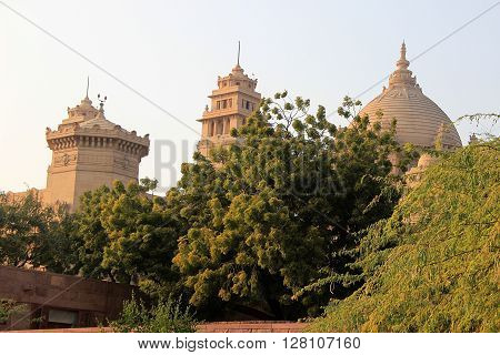 Stone domes of Umaid Bhavan Palace behind greenery Jodhpur Rajasthan India Asia