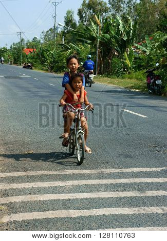 Asian Children Ride Bicycle In Danger