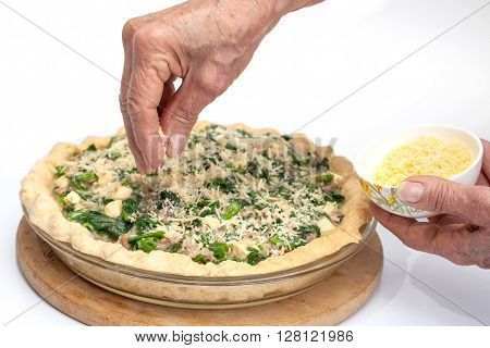 Quiche lorraine preparation : Adding parmesan cheese to the spinach and tuna quiche lorraine