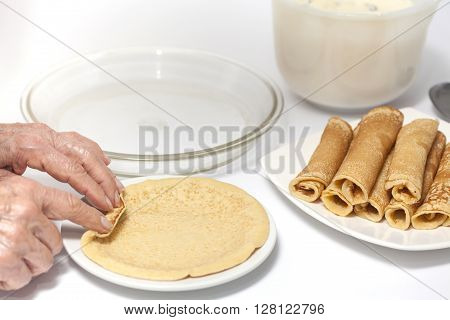 View of a woman hand rolling up a crepe