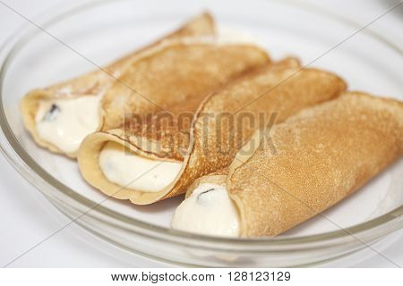 Topfen fullen rolled and filled crepes on a baking dish