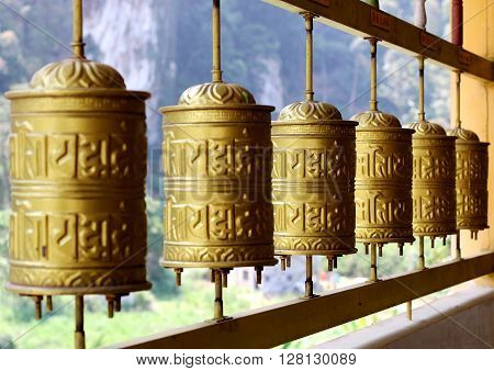 Buddhist prayer wheels which are prominent in a Tibetan temple or monastery.