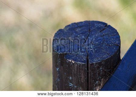 part of an old column from a wooden fence for the ranch closeup on an indistinct background