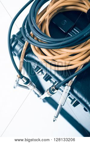 Close-up of guitar amplifier with jack cable.