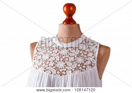 White sleeveless summer top. White top on armless mannequin. Girl's high-quality summer garment. Last size in stock.