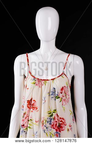 Summer sarafan and small necklace. Mannequin wearing necklace with pendant. Woman's brand new apparel. Exclusive jewelry in stock.