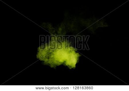 Light green powder explosion on black background. Colored powder cloud. Colorful dust explode. Paint Holi.