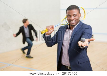 Happy Afro-American offering match in squash for concluding contract between two companies on squah court.
** Note: Visible grain at 100%, best at smaller sizes
