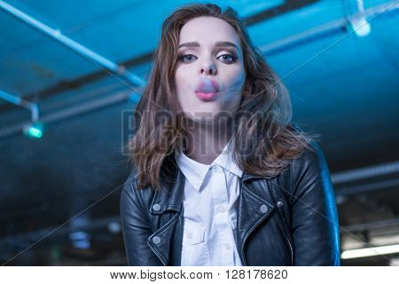 pretty woman smoking e-cigarette , shisha in the carpark