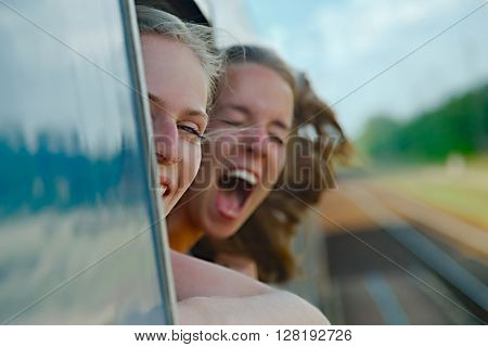 Two girls enjoying train travel