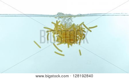 Maccheroni pasta falling in water