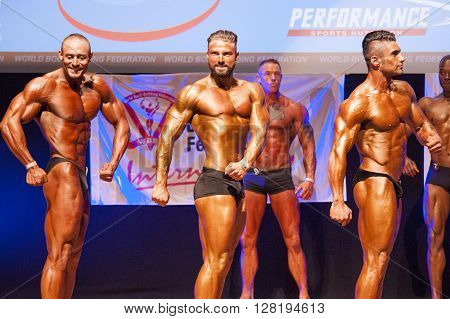 MAASTRICHT THE NETHERLANDS - OCTOBER 25 2015: Male bodybuilders flex their muscles and show their best side pose at the World Grandprix Bodybuilding and Fitness of the WBBF-WFF on October 25 2015 at the MECC Theatre in Maastricht the Netherlands