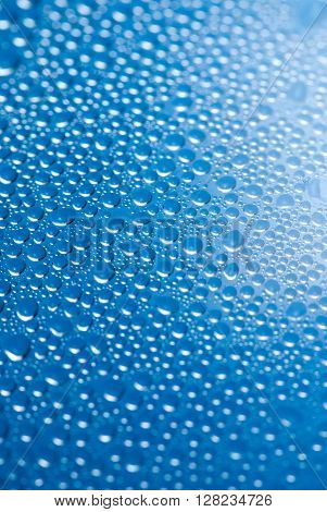 close-up of water drops on the blue background.