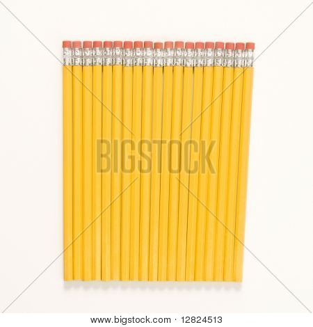 Group of new unsharpened pencils lined up in an even row.