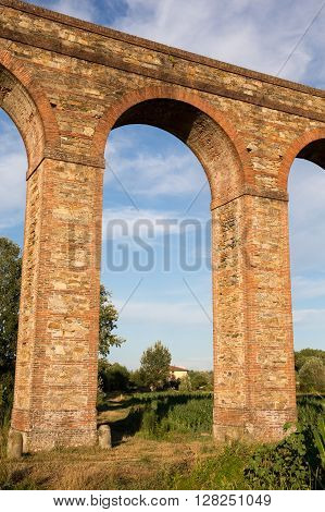 Old Arch - Arch section of the Nottolini Aqueduct in Tuscany near Lucca Italy. Warm evening light with classic Tuscan textures and tones. Concepts could include Travel Architecture Europe others.
