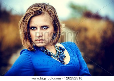 Closeup portrait of young woman in bluea dress